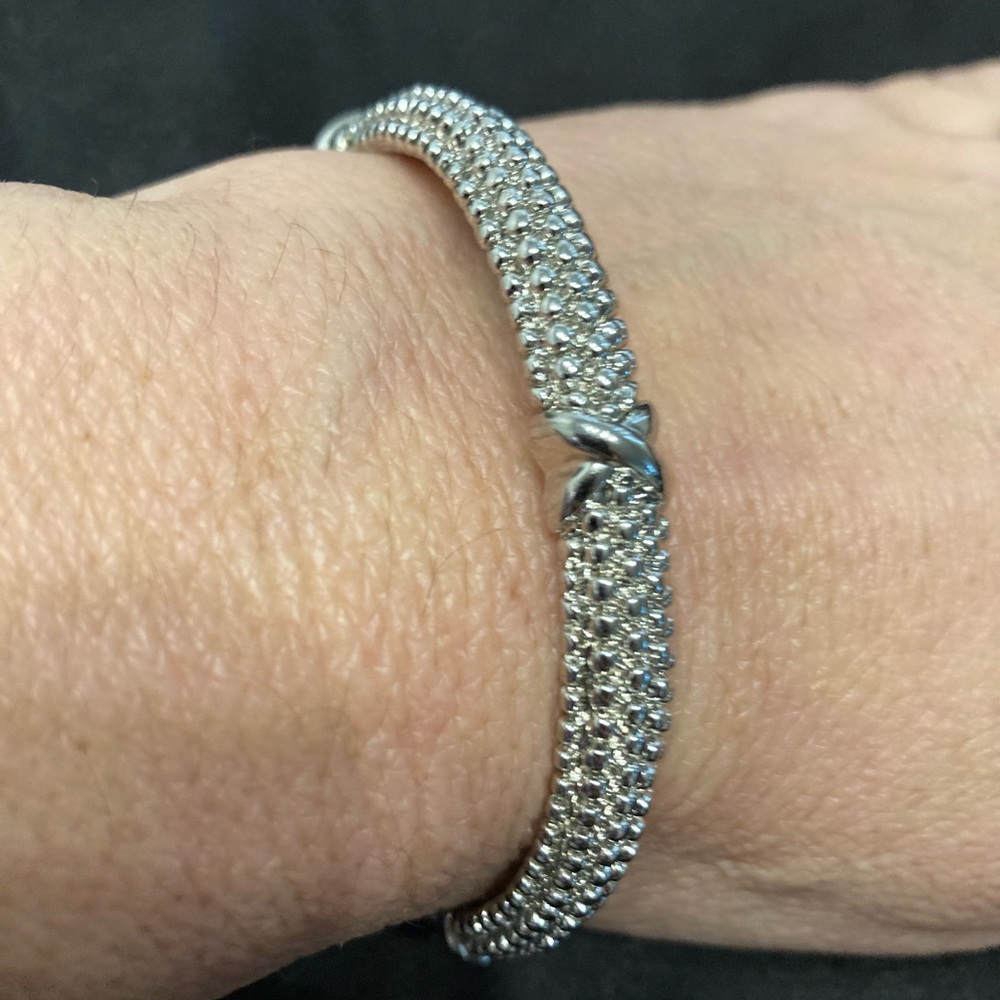 Silver Beveled Bangle bracelet with an Iconic Knot Parklane